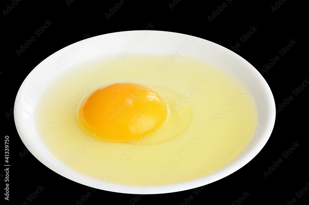 Egg in a white plate on black background Egg in a white plate on black background