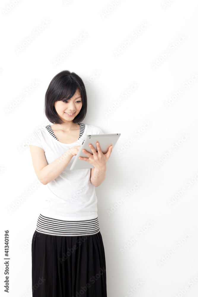 attractive asian woman using tablet computer attractive asian woman using tablet computer