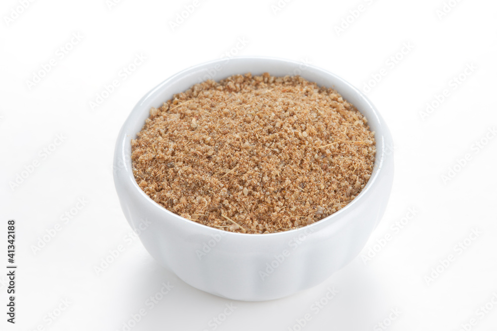 Cumin ground in a white bowl on white background. Cumin ground in a white bowl on white background.