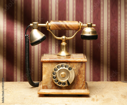 A beautiful old vintage telephone on a striped background
