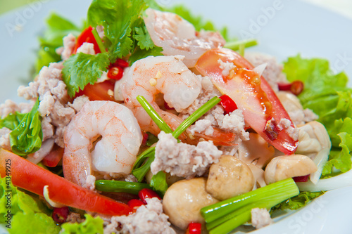 Thai dressed spicy salad with prawn, pork, green herbs and nuts