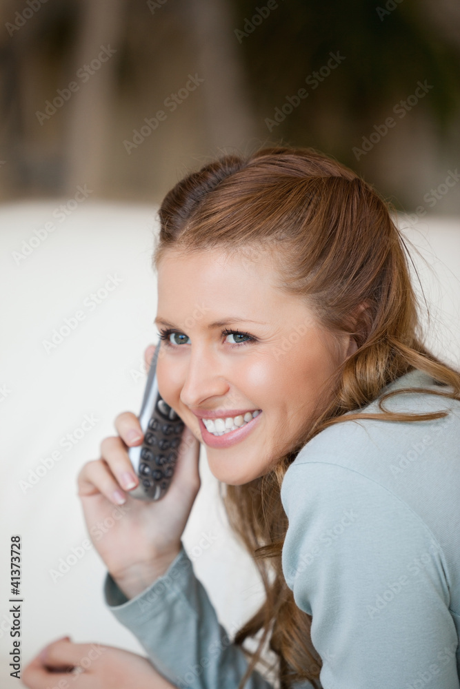 Woman smiling while phoning