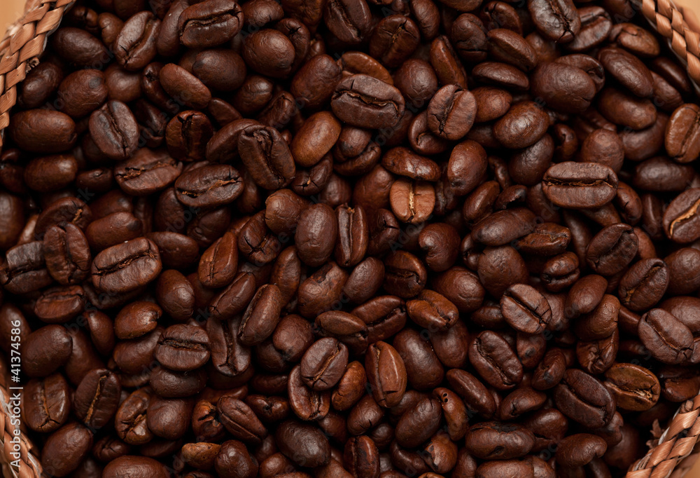 Close up of a basket full of dark coffee beans Close up of a basket full of dark coffee beans