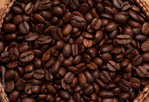 Close up of a basket full of dark coffee beans