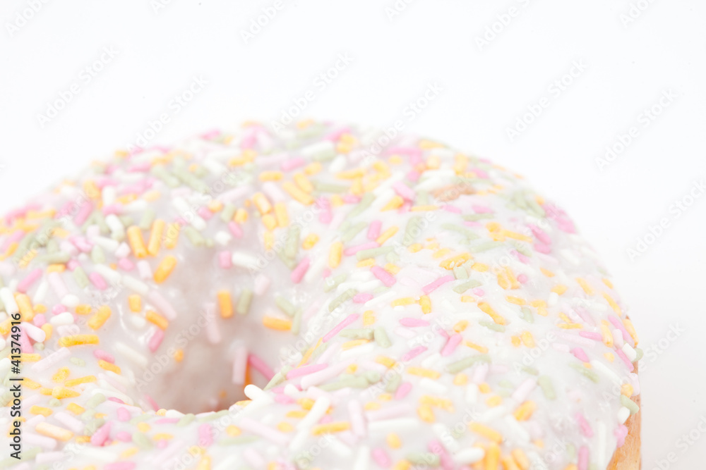 Close up on doughnut with multi coloured icing sugar Close up on doughnut with multi coloured icing sugar