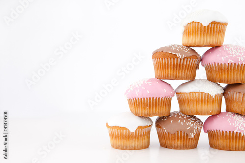 Pyramid of many muffins with icing sugar