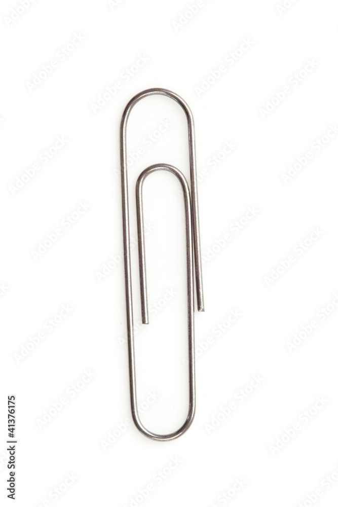 Close up of a grey paperclip on the floor