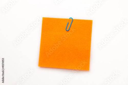 Orange adhesive note with a paperclip