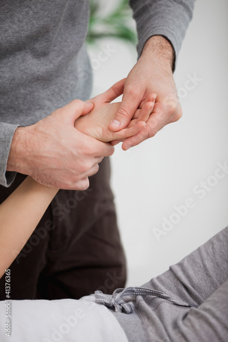 Physiotherapist massaging the hand of a patient