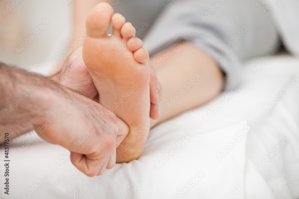 Ball of a foot being touched by a doctor Ball of a foot being touched by a doctor