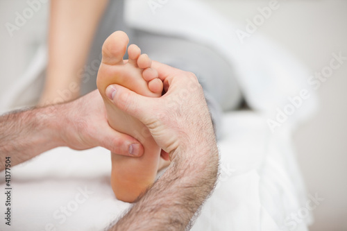 Man using his two hands to massage a foot © WavebreakmediaMicro