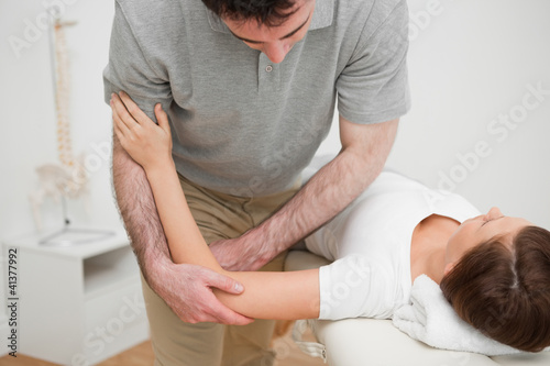 Woman lying while being massaged