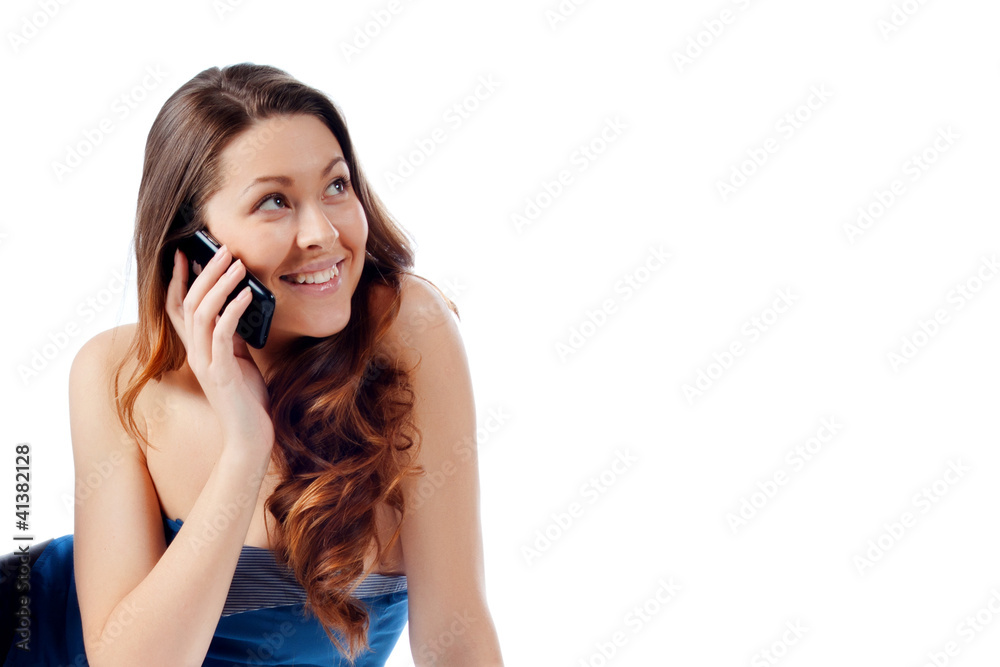 Young beautiful girl talking on a cell phone Young beautiful girl talking on a cell phone