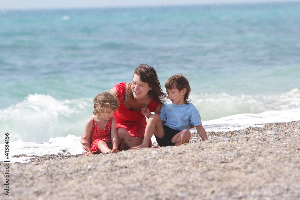 happy mother and two children on sea background