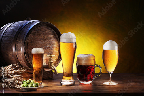 Beer barrel with beer glasses on a wooden table.