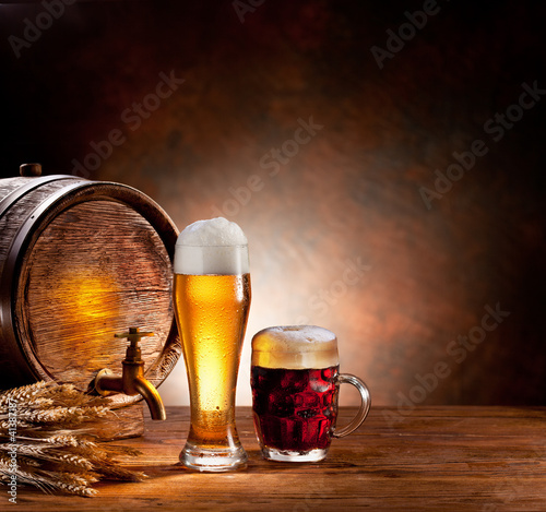 Beer barrel with beer glasses on a wooden table.