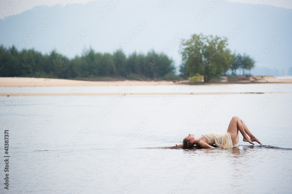 beautiful young girl lying on the surface of the water Stock Photo ...