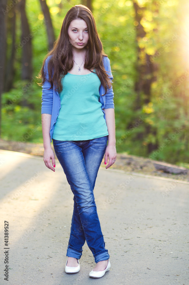 Young woman in blue shirt in park Young woman in blue shirt in park