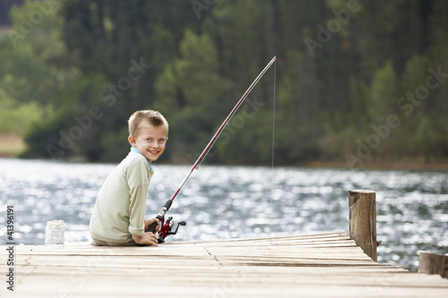 Young boy fishing on a jetty