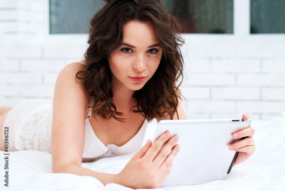 Beautiful young woman using tablet computer Beautiful young woman using tablet computer