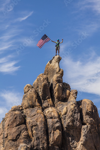 Waving a flag on the summit.