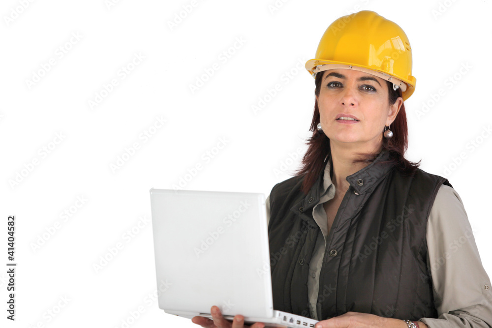 Female architect holding laptop computer Female architect holding laptop computer