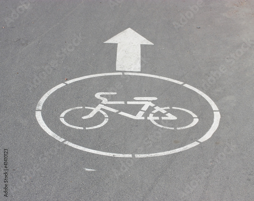 White arrow and sign a bicycle.