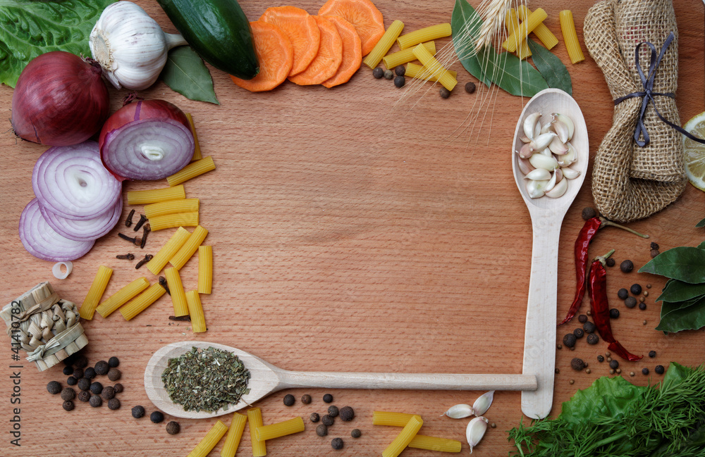 Frame made of spices and vegetables on a wooden table. Frame made of spices and vegetables on a wooden table.