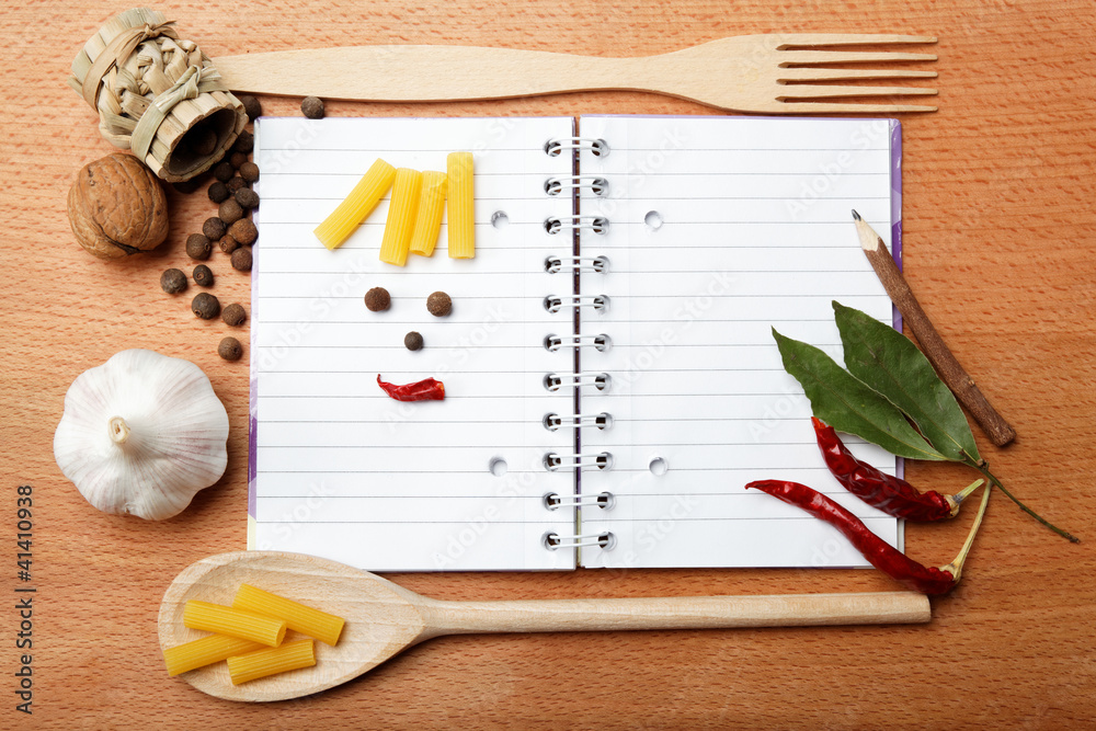 Fototapeta premium notebook for recipes and spices on wooden table
