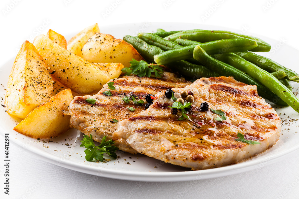 Grilled steaks, baked potatoes and vegetables Grilled steaks, baked potatoes and vegetables