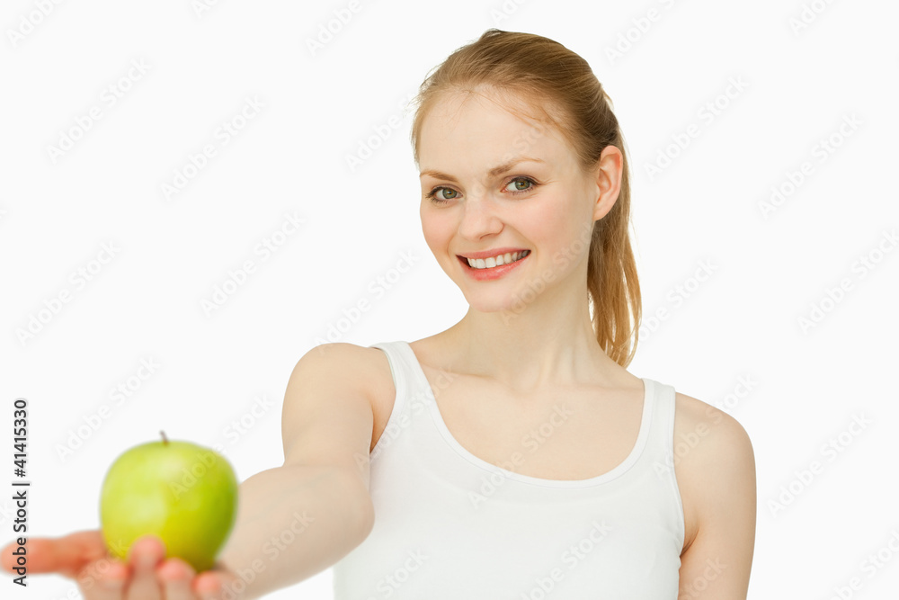 Woman smiling while holding an apple Woman smiling while holding an apple