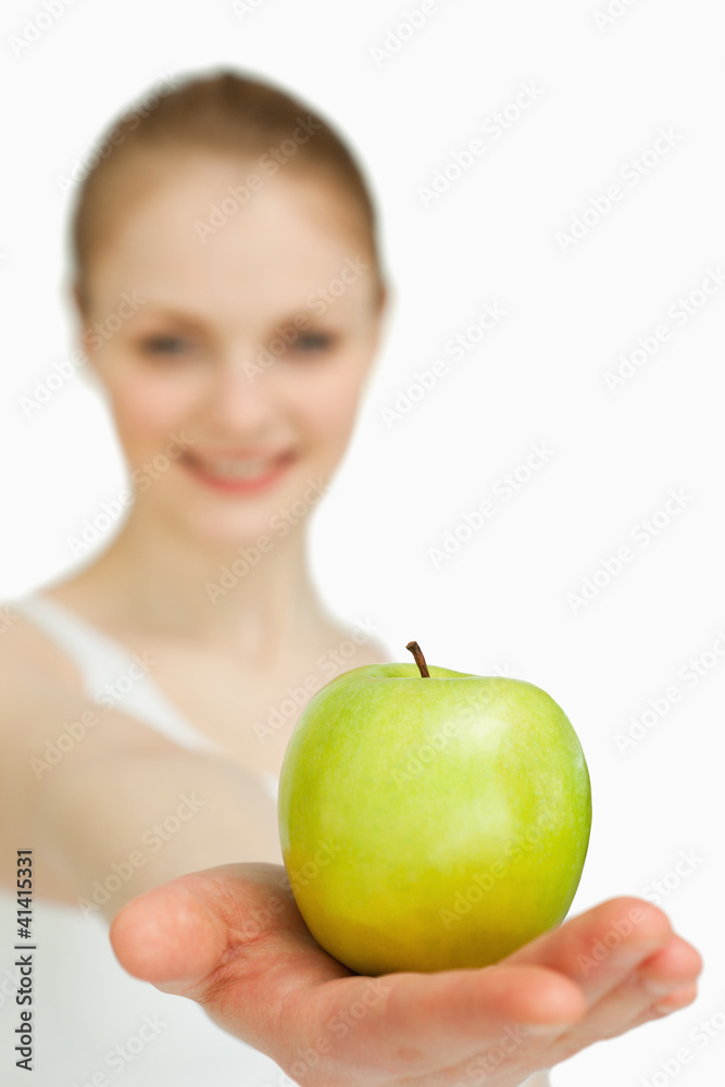 Close up of a woman presenting an apple Close up of a woman presenting an apple