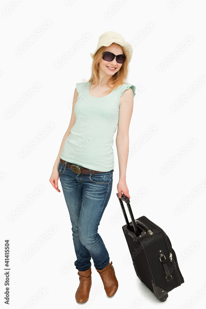 Woman holding a suitcase while standing Woman holding a suitcase while standing