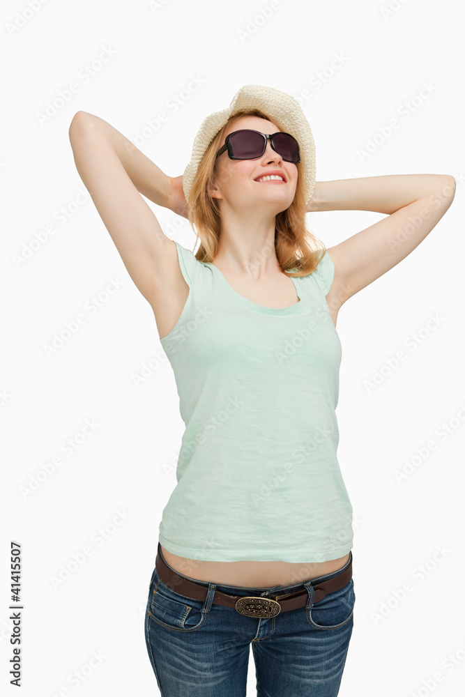 Woman smiling while wearing a summer hat Woman smiling while wearing a summer hat
