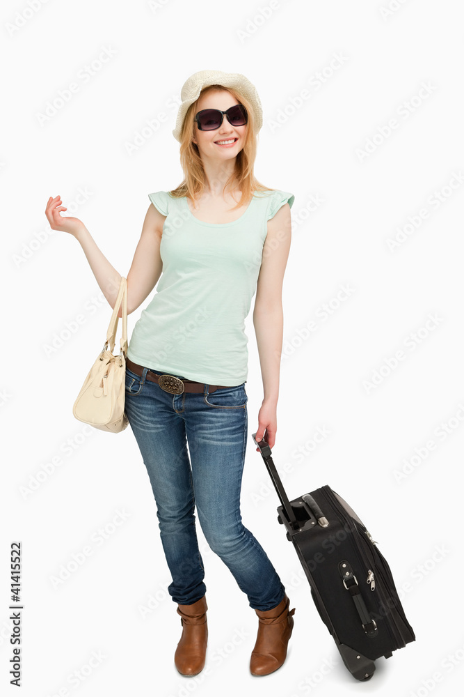 Woman standing while holding baggages Woman standing while holding baggages