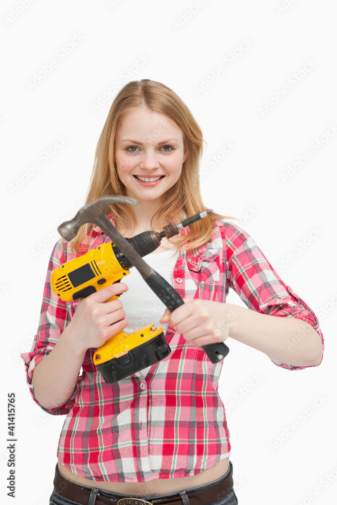 Young woman holding tools Young woman holding tools