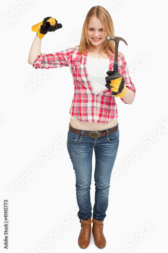 Woman standing while holding a hammer