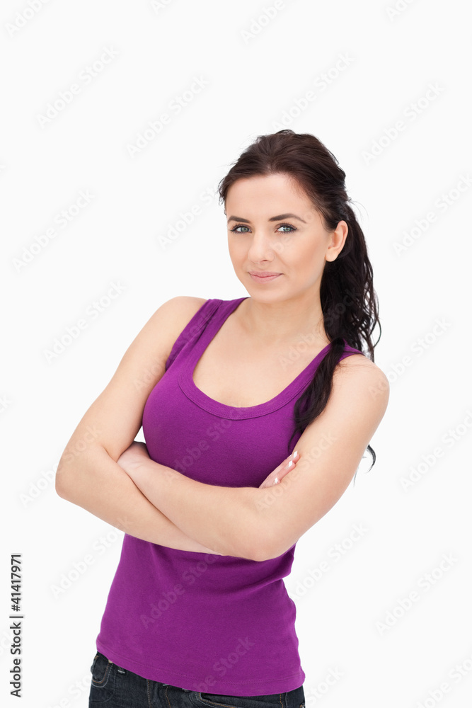 Brunette in purple top tank with folded arms Brunette in purple top tank with folded arms