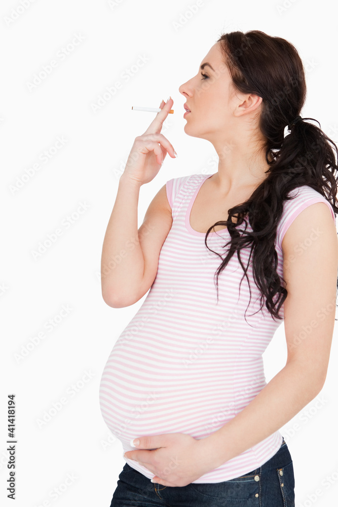 Young pregnant woman smoking
