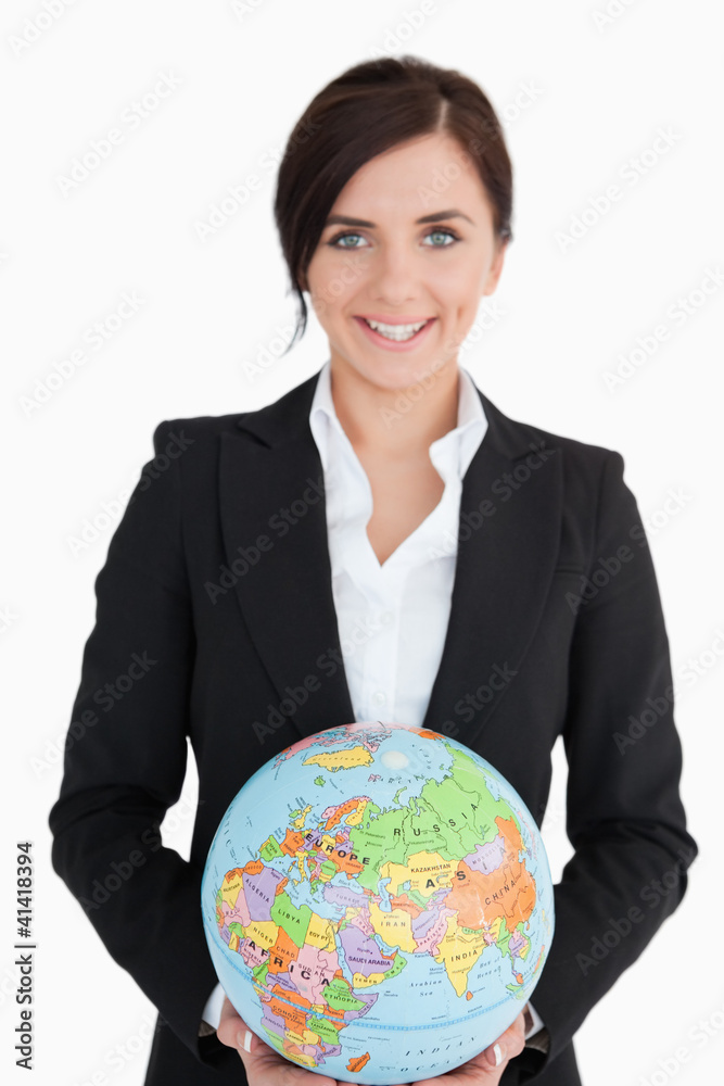 Smiling woman in suit holding an earth globe Smiling woman in suit holding an earth globe