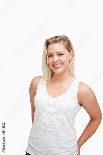 Relaxed blonde woman standing with her hands behind her back © WavebreakmediaMicro