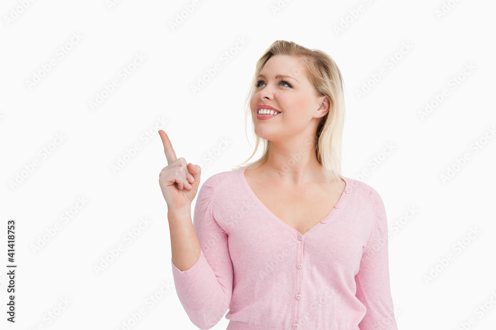 Smiling woman pointing at a blank space Smiling woman pointing at a blank space