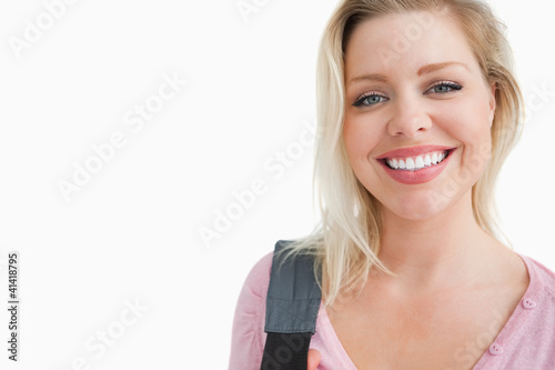 Happy young woman holding a shoulder bag