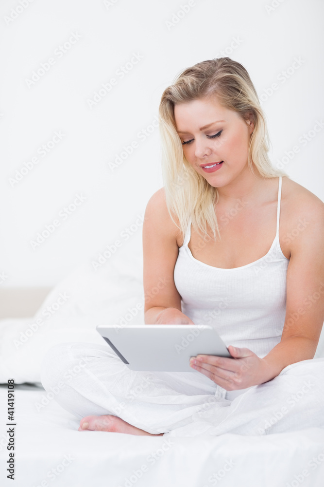 Young woman using an ebook while sitting