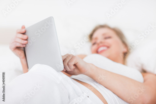 Woman laughing while using an ebook