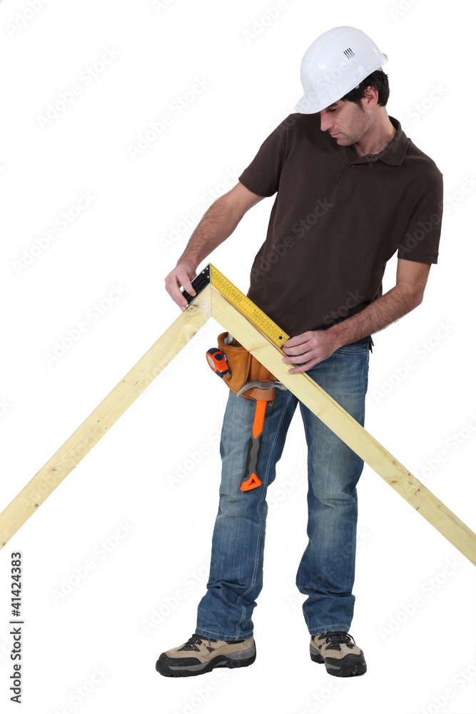 Worker using a right angle ruler to measure an angle Worker using a right angle ruler to measure an angle