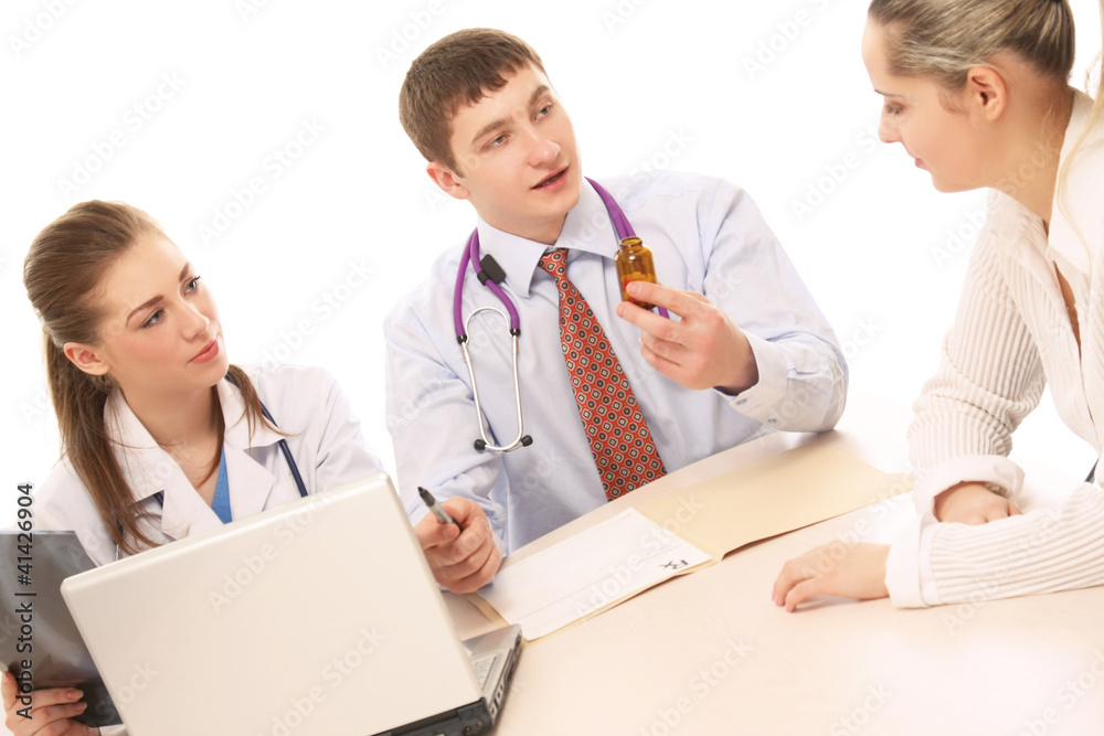 Obraz premium Two doctors making prescription for a patient on white