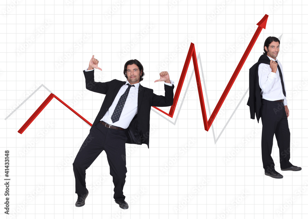 Businessman stood by graph showing profit Businessman stood by graph showing profit