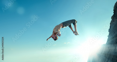 Excited young man jumping in air