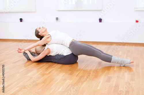 Women doing yoga exercise at gym